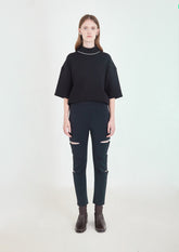 CALÇA COM RECORTES DE TK